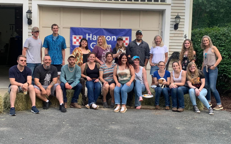 Hanson Grain Co. family posed sitting on square bales.